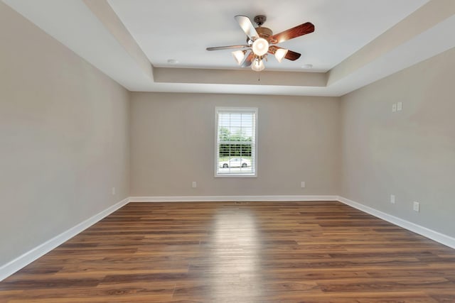 288 Springwater Dr, Summertown, TN 38483 - spare room with ceiling fan, dark wood-style flooring, and a tray ceiling