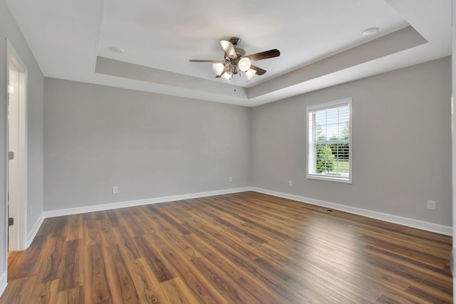 288 Springwater Dr, Summertown, TN 38483 - unfurnished room featuring a tray ceiling, ceiling fan, and dark wood finished floors