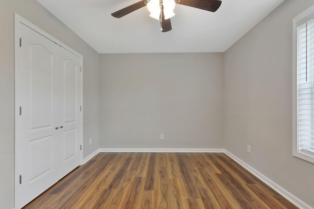 288 Springwater Dr, Summertown, TN 38483 - unfurnished bedroom with dark wood-type flooring, multiple windows, and a ceiling fan