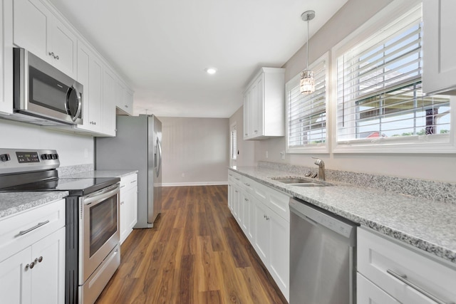288 Springwater Dr, Summertown, TN 38483 - kitchen with stainless steel appliances, dark wood finished floors, white cabinetry, hanging light fixtures, and light stone counters