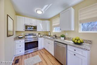 1112 Brookside Ave, Maryville, TN 37804 - kitchen featuring appliances with stainless steel finishes, white cabinets, and light wood-style floors