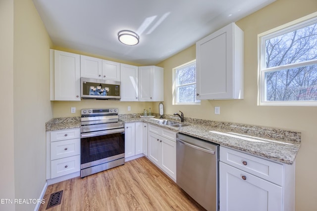 1112 Brookside Ave, Maryville, TN 37804 - kitchen featuring stainless steel appliances, white cabinets, and light wood-style flooring