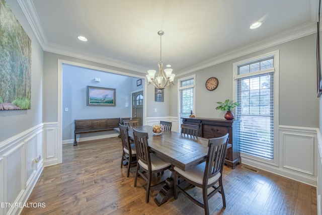 2023 Legacy Ln, Maryville, TN 37803 - dining area featuring a chandelier, wainscoting, a decorative wall, ornamental molding, and wood finished floors