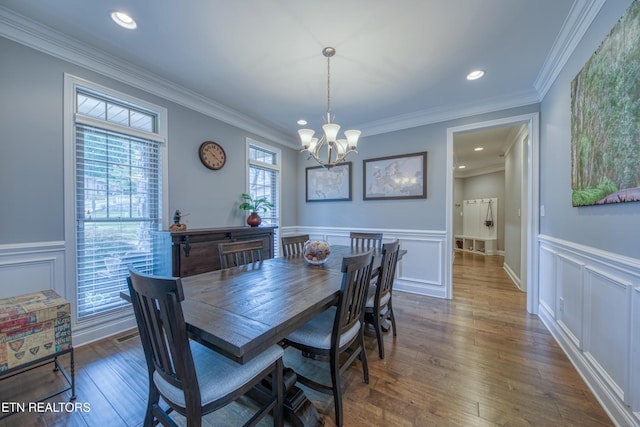 2023 Legacy Ln, Maryville, TN 37803 - dining area with a chandelier, a decorative wall, wainscoting, dark wood-style floors, and ornamental molding
