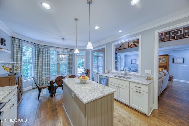 2023 Legacy Ln, Maryville, TN 37803 - kitchen featuring stainless steel dishwasher, ornamental molding, light wood-style floors, a center island, and light stone countertops