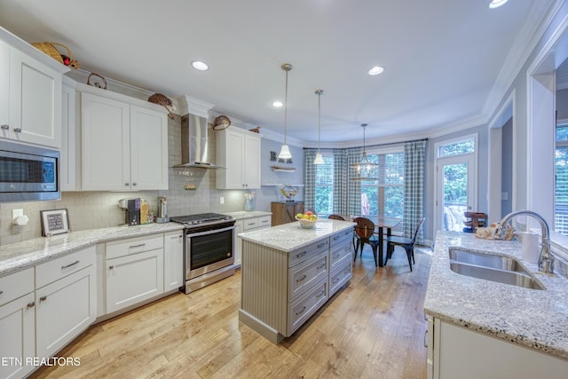 2023 Legacy Ln, Maryville, TN 37803 - kitchen with stainless steel appliances, wall chimney exhaust hood, ornamental molding, a kitchen island, and white cabinetry