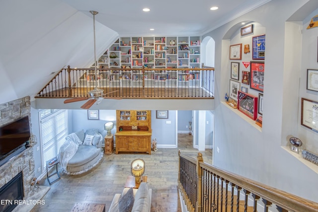 2023 Legacy Ln, Maryville, TN 37803 - living area featuring a stone fireplace, wood finished floors, recessed lighting, ceiling fan, and arched walkways