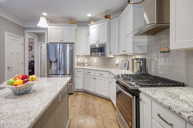 2023 Legacy Ln, Maryville, TN 37803 - kitchen featuring stainless steel appliances, wall chimney range hood, white cabinets, tasteful backsplash, and light wood-style flooring