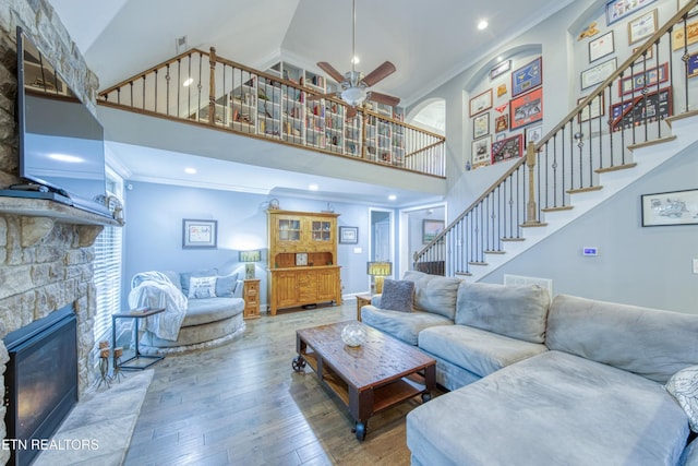 2023 Legacy Ln, Maryville, TN 37803 - living room with a high ceiling, ornamental molding, stairway, ceiling fan, and wood-type flooring