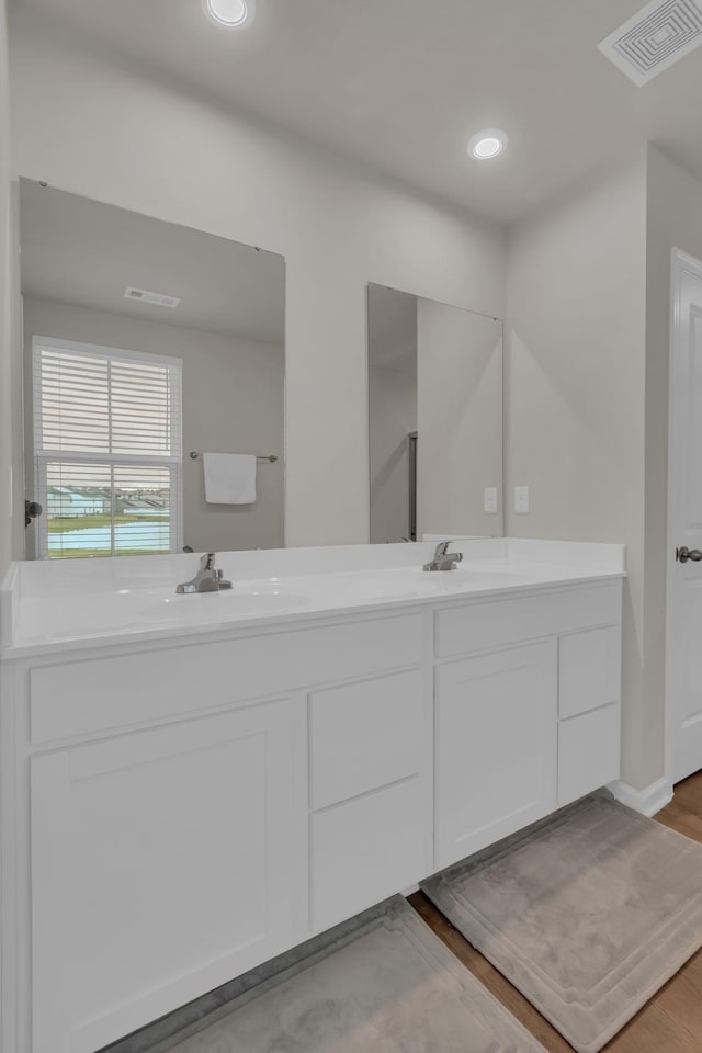 1830 Quail Run Way, Spring Hill, TN 37174 - bathroom featuring double vanity, wood finished floors, and recessed lighting