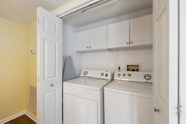 306 Norvich Ct, Franklin, TN 37069 - laundry area with washing machine and dryer, cabinet space, a textured ceiling, and dark wood-style flooring