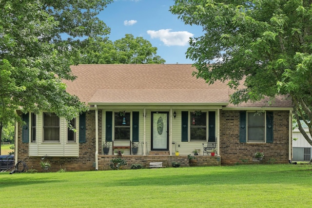 10615 Owens Chapel Rd, Springfield, TN 37172 - view of front of house with a front yard, a porch, brick siding, and roof with shingles