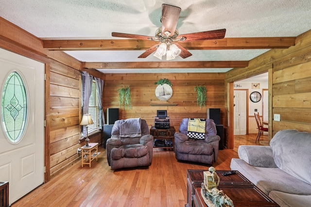 10615 Owens Chapel Rd, Springfield, TN 37172 - living area featuring wooden walls, a textured ceiling, beamed ceiling, light wood-style floors, and ceiling fan