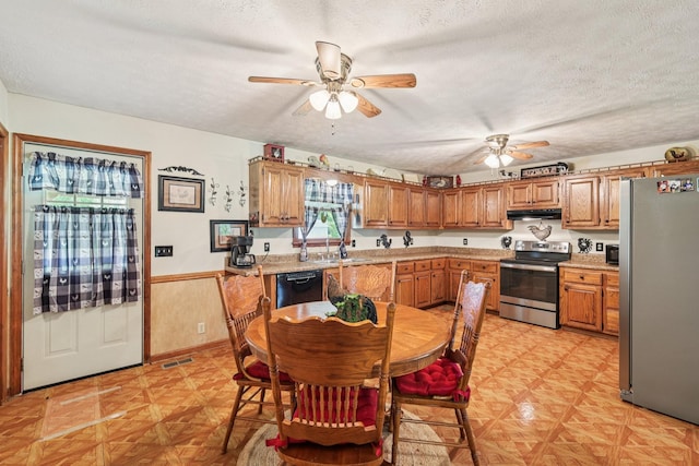 10615 Owens Chapel Rd, Springfield, TN 37172 - kitchen with appliances with stainless steel finishes, a ceiling fan, light countertops, a textured ceiling, and a wainscoted wall