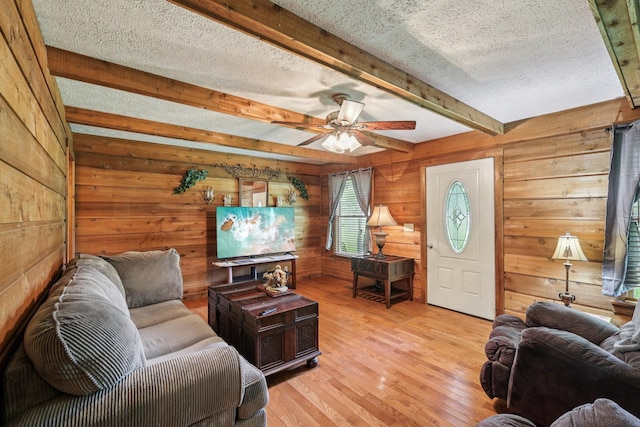 10615 Owens Chapel Rd, Springfield, TN 37172 - living area featuring wooden walls, beam ceiling, light wood-style flooring, a textured ceiling, and ceiling fan