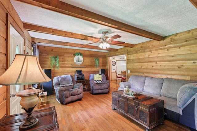 10615 Owens Chapel Rd, Springfield, TN 37172 - living area featuring wood walls, beam ceiling, wood finished floors, a textured ceiling, and ceiling fan