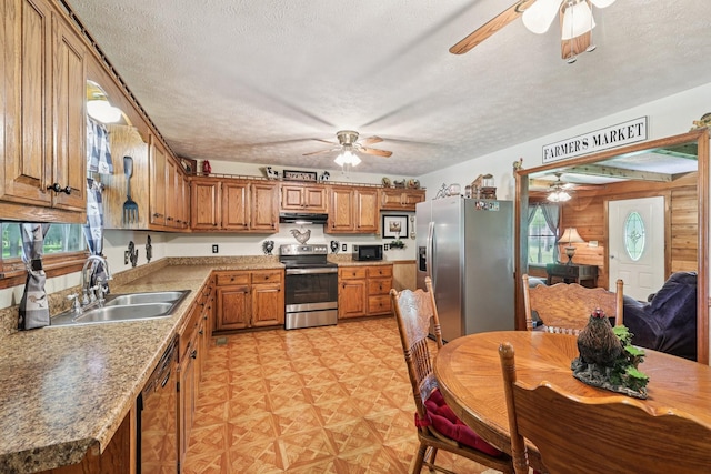 10615 Owens Chapel Rd, Springfield, TN 37172 - kitchen with black appliances, ceiling fan, under cabinet range hood, brown cabinetry, and a textured ceiling