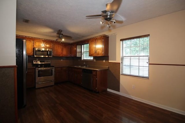 1211 Patton Pl, Oak Grove, KY 42262 - kitchen with stainless steel appliances, a ceiling fan, dark wood finished floors, brown cabinetry, and a textured ceiling