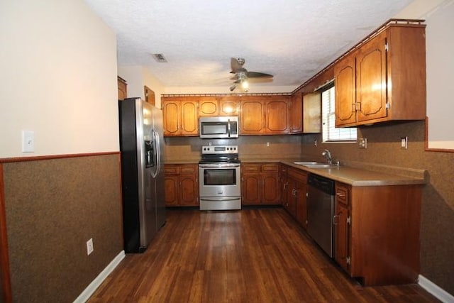1211 Patton Pl, Oak Grove, KY 42262 - kitchen with stainless steel appliances, brown cabinets, dark wood-type flooring, and a wainscoted wall