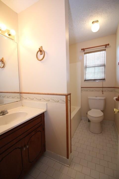 1211 Patton Pl, Oak Grove, KY 42262 - bathroom with tile patterned flooring, vanity, a textured ceiling, tub / shower combination, and wainscoting