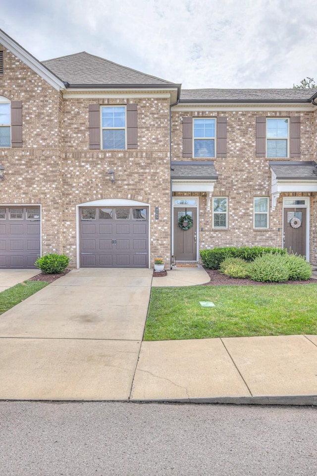 3105 Defilade Dr, Murfreesboro, TN 37128 - view of front facade with driveway, a garage, brick siding, and a shingled roof