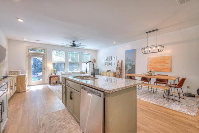 3105 Defilade Dr, Murfreesboro, TN 37128 - kitchen with stainless steel dishwasher, light wood-type flooring, light stone countertops, pendant lighting, and an island with sink
