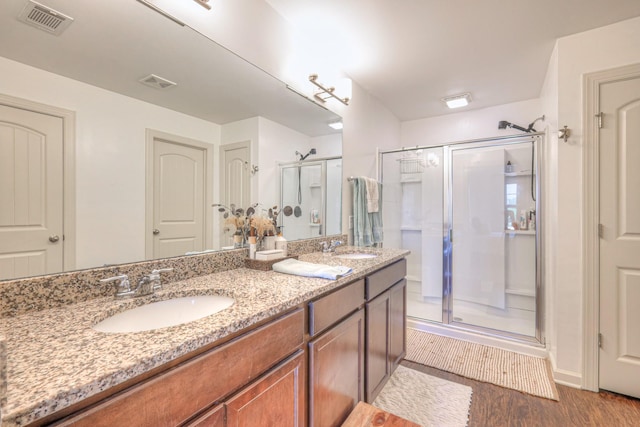 3105 Defilade Dr, Murfreesboro, TN 37128 - bathroom featuring a shower stall, double vanity, and wood finished floors