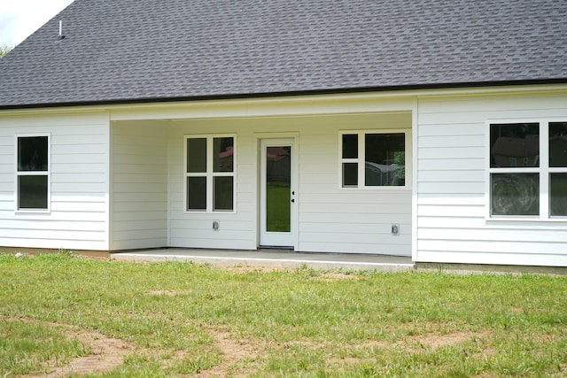 825A College St, Portland, TN 37148 - rear view of house with a lawn, roof with shingles, and a patio