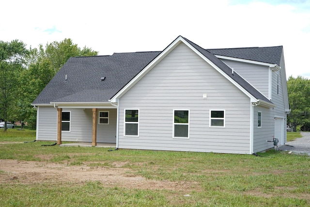 825B College St, Portland, TN 37148 - back of house featuring a lawn, an attached garage, and roof with shingles