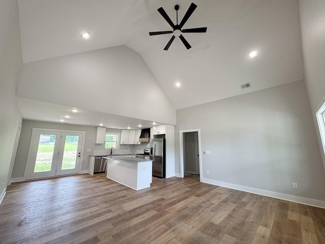 825B College St, Portland, TN 37148 - kitchen with appliances with stainless steel finishes, open floor plan, ceiling fan, high vaulted ceiling, and white cabinets