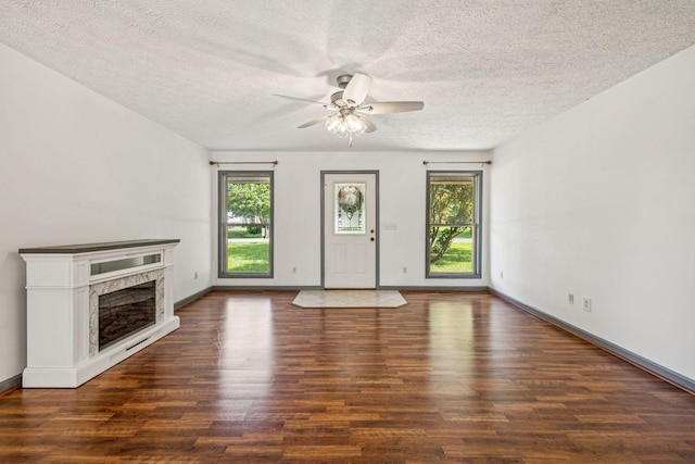 5531 Willow Oak Dr, Baxter, TN 38544 - unfurnished living room with plenty of natural light, ceiling fan, a fireplace, wood finished floors, and a textured ceiling