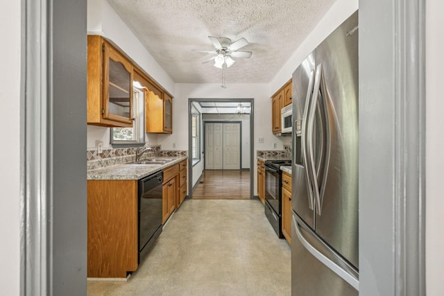 5531 Willow Oak Dr, Baxter, TN 38544 - kitchen with black appliances, brown cabinetry, light countertops, a textured ceiling, and a ceiling fan