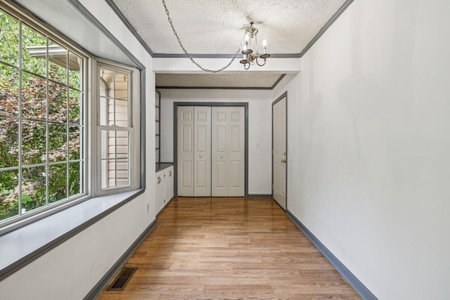 5531 Willow Oak Dr, Baxter, TN 38544 - entryway with a chandelier, a textured ceiling, light wood finished floors, and ornamental molding