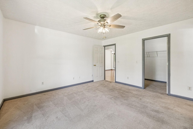 5531 Willow Oak Dr, Baxter, TN 38544 - unfurnished bedroom featuring carpet floors, a walk in closet, ceiling fan, a textured ceiling, and a closet