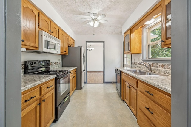 5531 Willow Oak Dr, Baxter, TN 38544 - kitchen with black appliances, light countertops, a textured ceiling, a chandelier, and ceiling fan