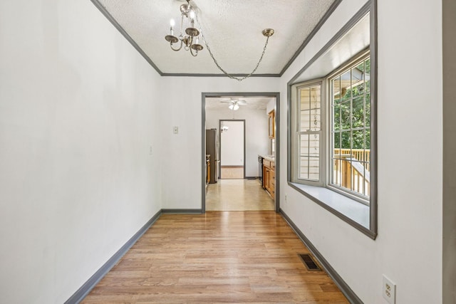 5531 Willow Oak Dr, Baxter, TN 38544 - hallway with a textured ceiling, light wood finished floors, a chandelier, and crown molding