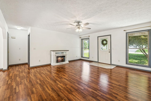 5531 Willow Oak Dr, Baxter, TN 38544 - unfurnished living room featuring wood finished floors, ceiling fan, a textured ceiling, and a lit fireplace