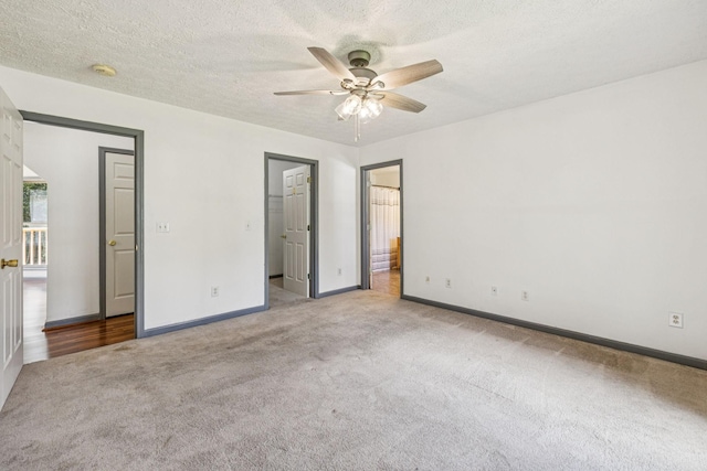 5531 Willow Oak Dr, Baxter, TN 38544 - unfurnished bedroom featuring carpet, a walk in closet, a ceiling fan, a textured ceiling, and ensuite bathroom