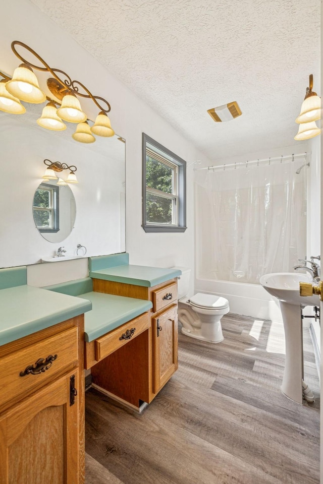 5531 Willow Oak Dr, Baxter, TN 38544 - bathroom with wood finished floors, shower / bath combo with shower curtain, a textured ceiling, and vanity