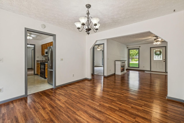 5531 Willow Oak Dr, Baxter, TN 38544 - unfurnished living room with a ceiling fan, wood finished floors, a chandelier, a textured ceiling, and a warm lit fireplace