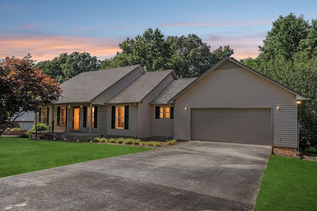 5531 Willow Oak Dr, Baxter, TN 38544 - view of front of home featuring driveway, a garage, a front lawn, and roof with shingles