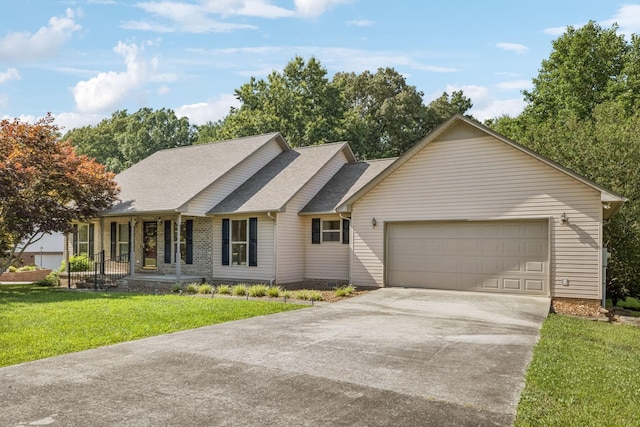 5531 Willow Oak Dr, Baxter, TN 38544 - ranch-style home with concrete driveway, a front lawn, an attached garage, roof with shingles, and covered porch