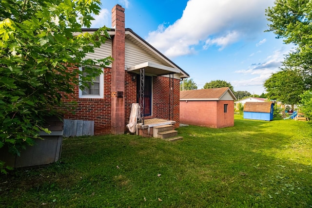 404 Mullican St, Mcminnville, TN 37110 - back of house featuring a lawn, brick siding, and a chimney