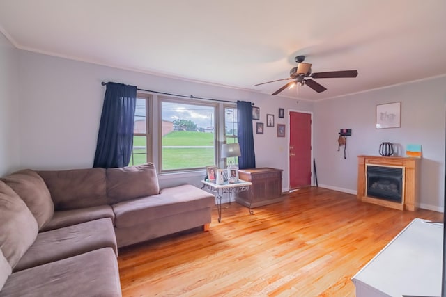 404 Mullican St, Mcminnville, TN 37110 - living room featuring light wood-type flooring, ceiling fan, a fireplace, and crown molding