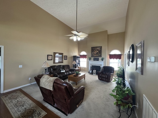 1239 Wentworth Dr, Gallatin, TN 37066 - living room featuring high vaulted ceiling, carpet flooring, a fireplace, a ceiling fan, and a textured ceiling