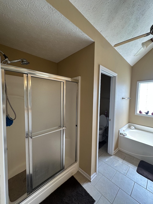 1239 Wentworth Dr, Gallatin, TN 37066 - full bath with tile patterned flooring, a textured ceiling, a shower stall, a garden tub, and lofted ceiling