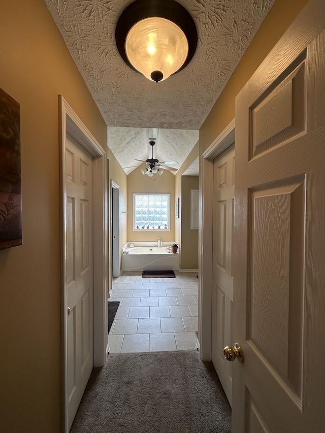 1239 Wentworth Dr, Gallatin, TN 37066 - hall with light tile patterned flooring, lofted ceiling, and light colored carpet