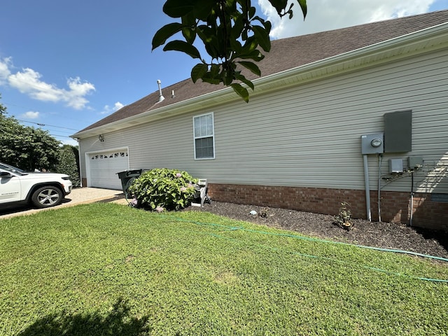 1239 Wentworth Dr, Gallatin, TN 37066 - view of home's exterior featuring an attached garage, a yard, a shingled roof, and concrete driveway