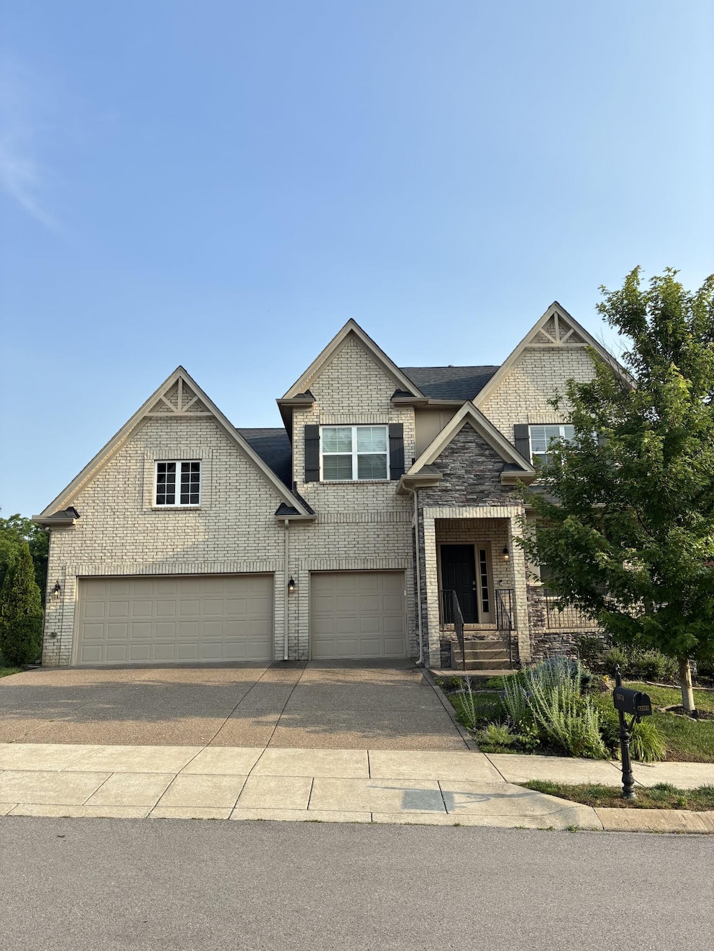 5074 Winslow Dr, Mount Juliet, TN 37122 - view of front of property featuring a garage, driveway, and brick siding