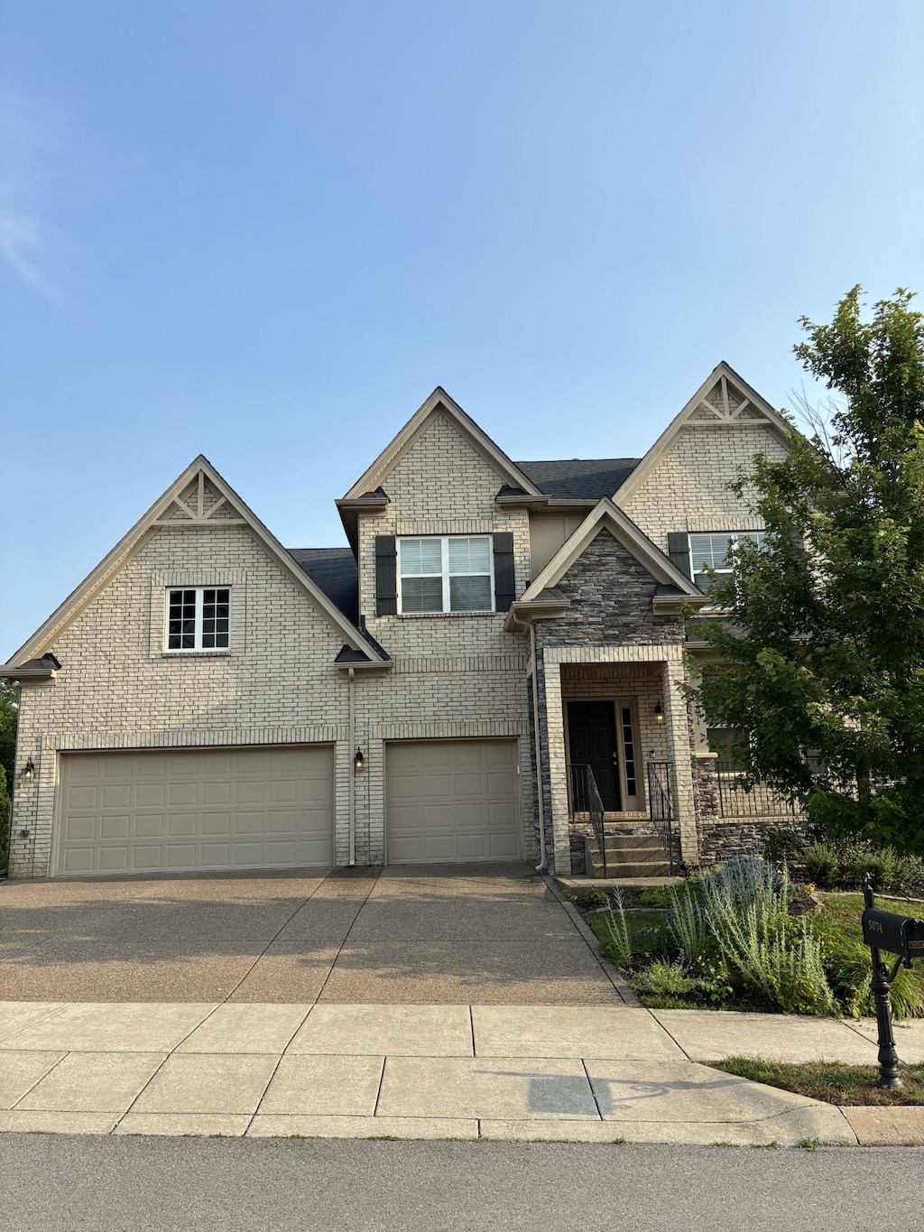 5074 Winslow Dr, Mount Juliet, TN 37122 - view of front of house with a garage, brick siding, and concrete driveway